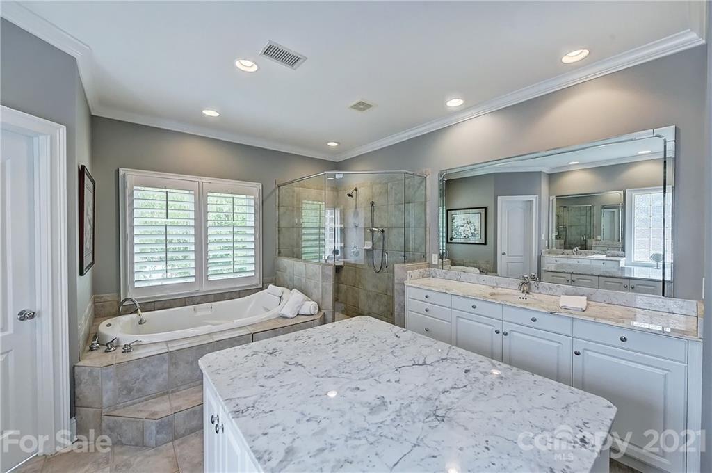 13710 Robert Walker Drive Davidson, NC 28036 - Photo 45 of 48 a spacious bathroom with a sink mirror and a bath tub