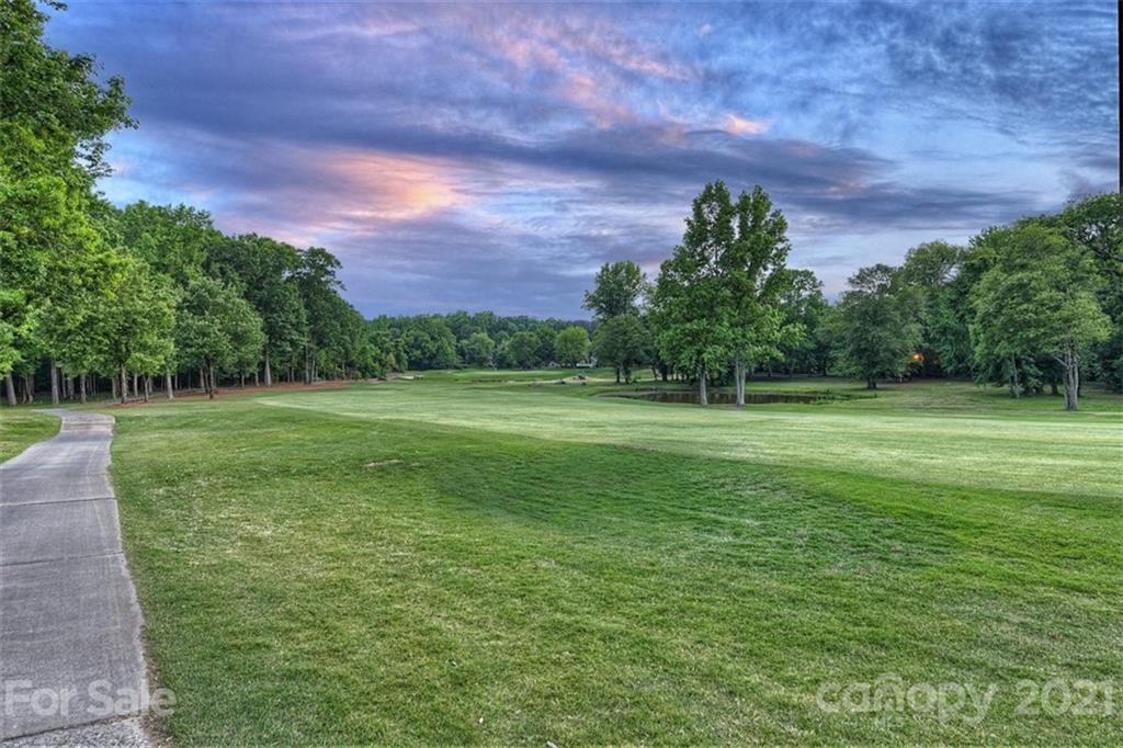13710 Robert Walker Drive Davidson, NC 28036 - Photo 10 of 48 a view of a green field with a house in the background