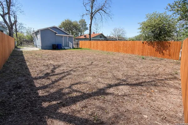 a view of a backyard with large trees