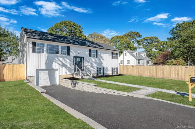 a front view of a house with a garden and yard