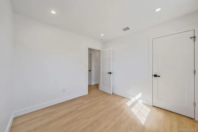 a view of a room with a window and wooden floor