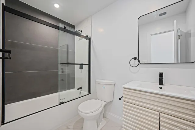 an empty room with wooden floor and window