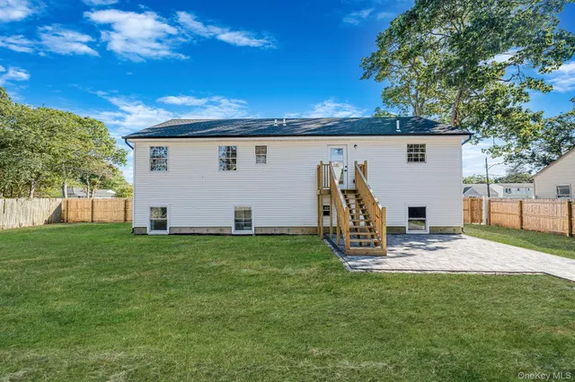 a view of a backyard with plants and a patio