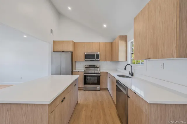 a kitchen with a sink a stove a refrigerator and cabinets