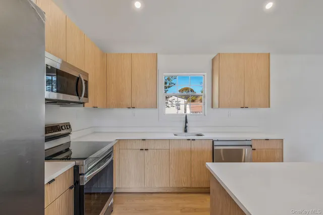 a kitchen with a sink a stove and cabinets