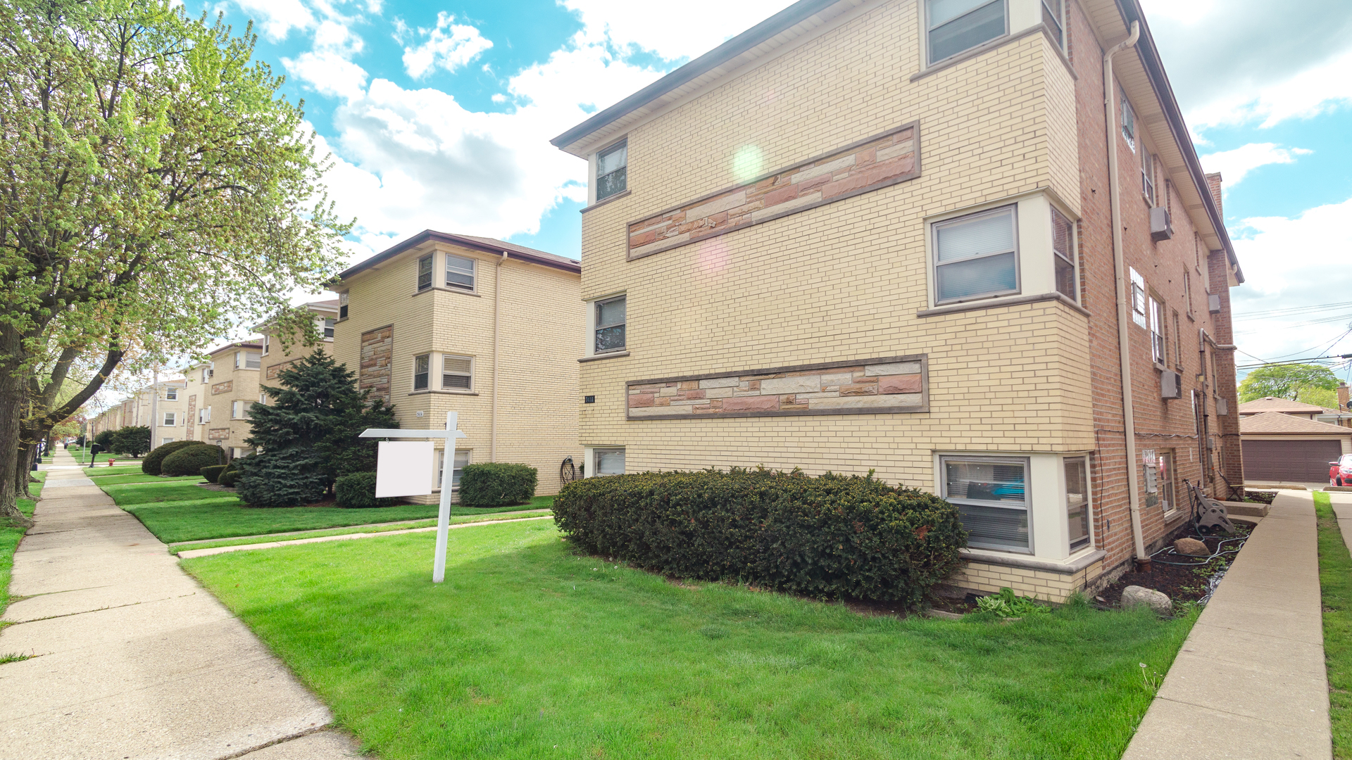7418 North Harlem Avenue, Unit 2 Chicago, IL 60631 - Photo 1 of 10 a view of a house with a yard and a large tree