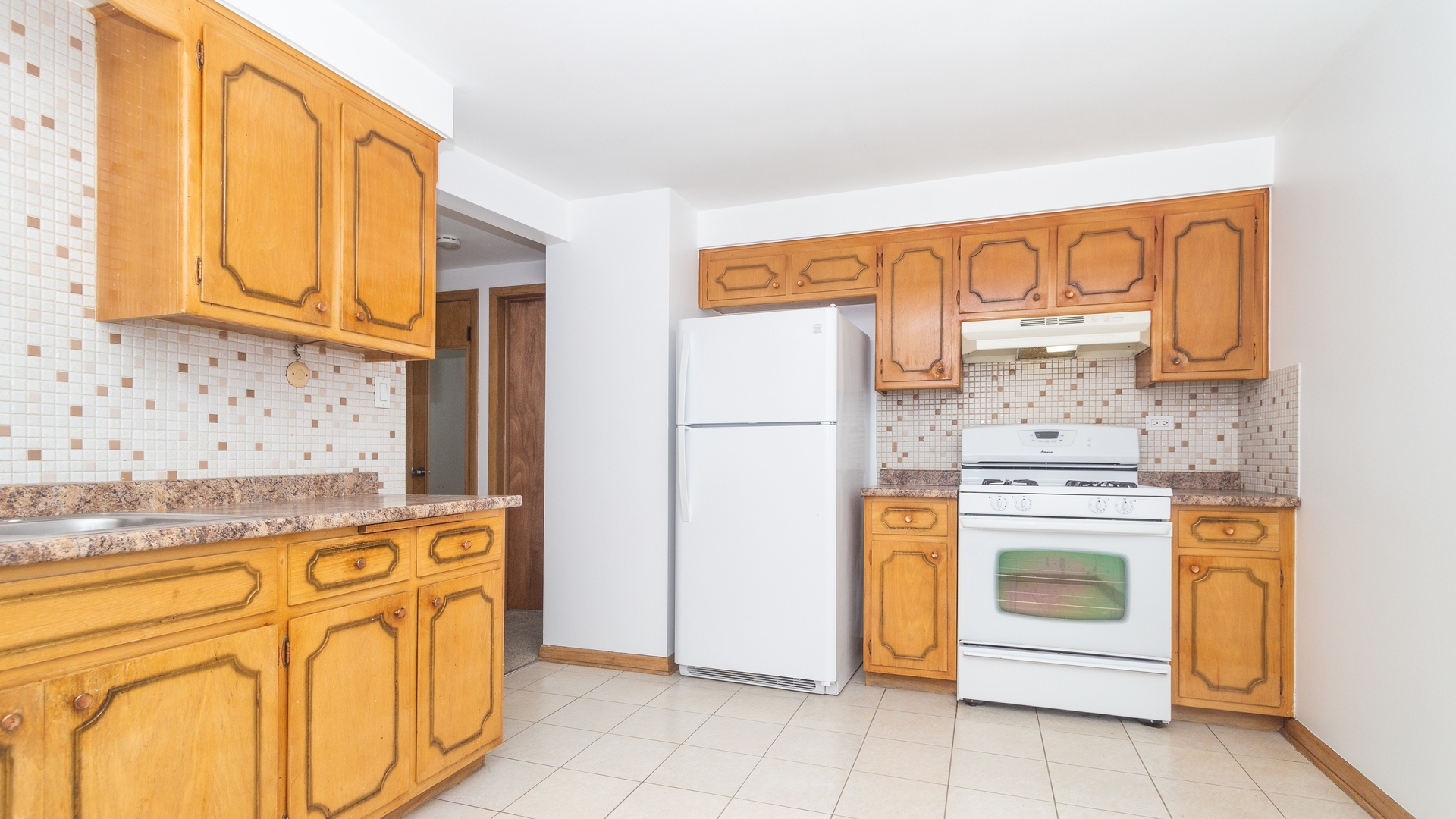 7418 North Harlem Avenue, Unit 2 Chicago, IL 60631 - Photo 5 of 10 a kitchen with stainless steel appliances granite countertop a stove a sink and a refrigerator with cabinets