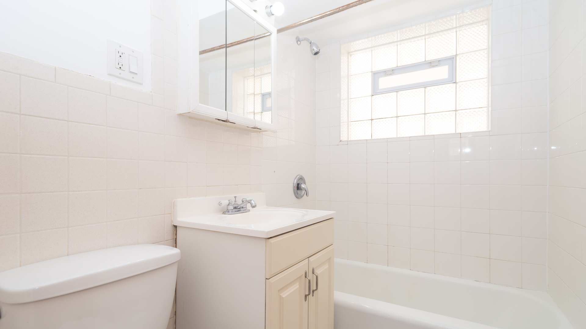 7418 North Harlem Avenue, Unit 2 Chicago, IL 60631 - Photo 7 of 10 a bathroom with a sink a toilet and a bathtub