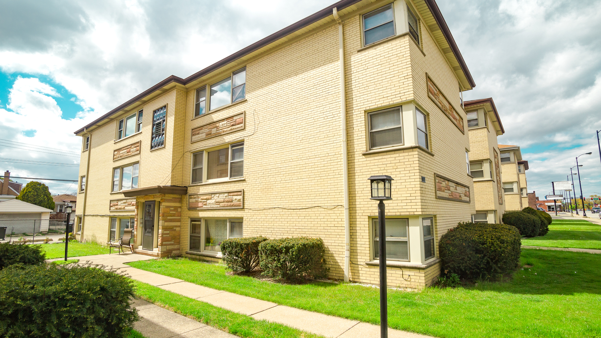 7418 North Harlem Avenue, Unit 2 Chicago, IL 60631 - Photo 8 of 10 a front view of a residential apartment building with a yard