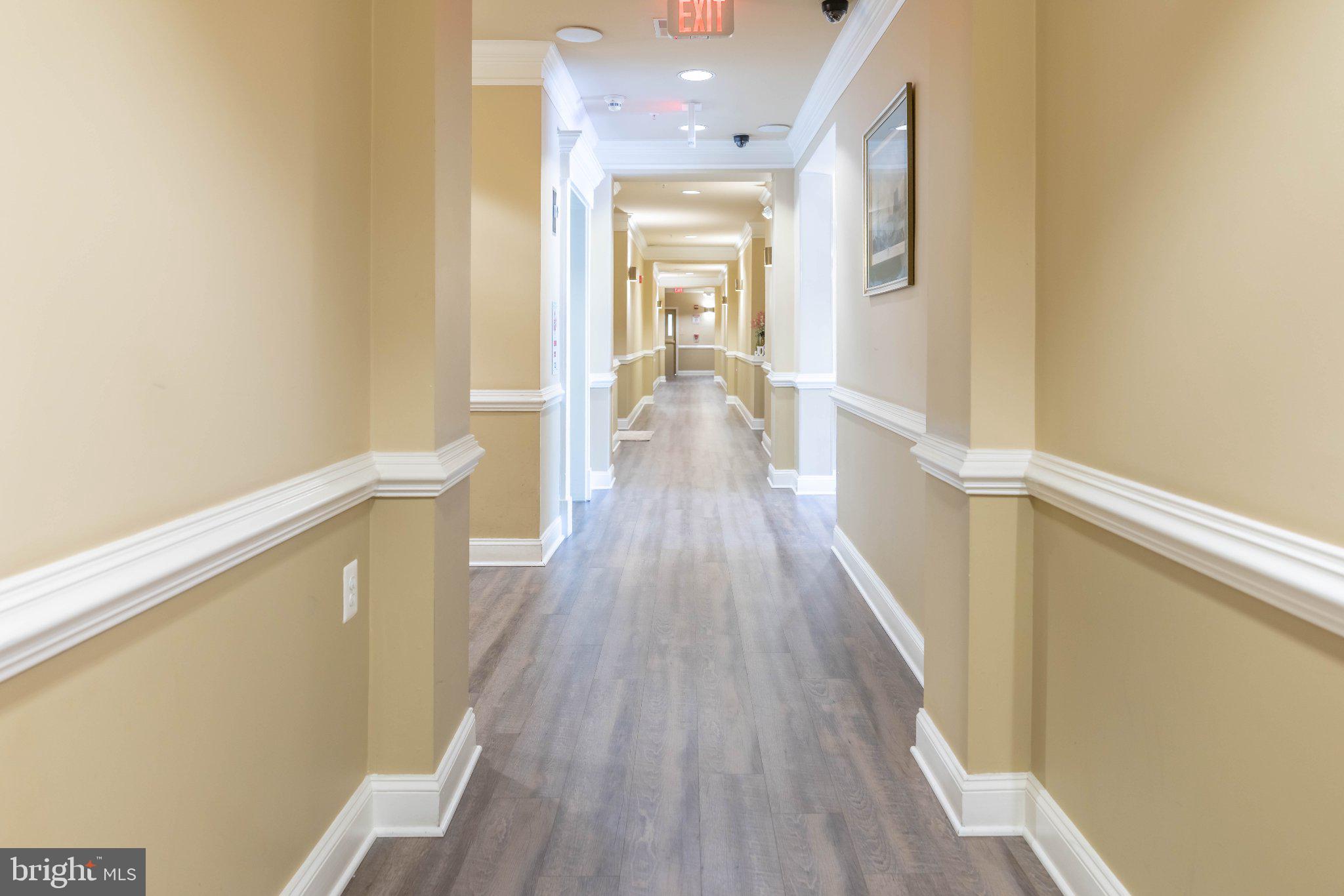 12824 Clarksburg Square Road, Unit 105 Clarksburg, MD 20871 - Photo 9 of 96 Inviting corridor with warm tones.