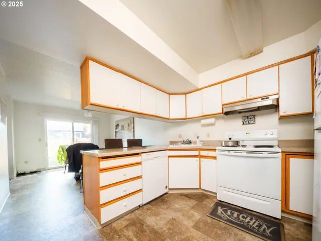 a kitchen with stainless steel appliances granite countertop a sink and cabinets