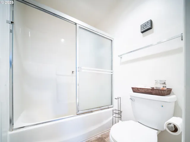 a white toilet sitting next to a bathroom sink