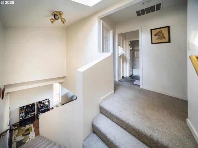 a view of a livingroom with wooden floor and stairs