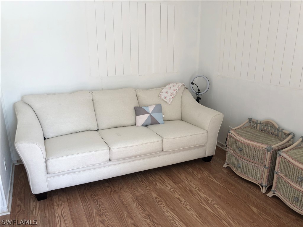 208 Davis Road Lehigh Acres, FL 33936 - Photo 12 of 20 a living room with furniture and a wooden floor