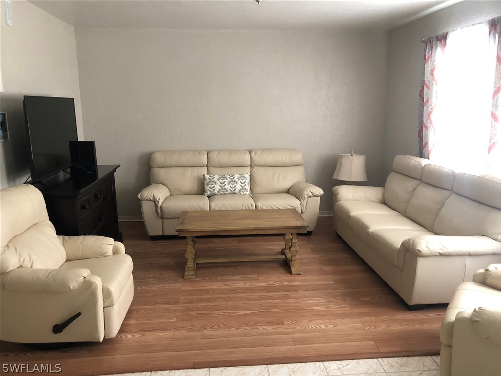 208 Davis Road Lehigh Acres, FL 33936 - Photo 16 of 20 a living room with furniture and a rug