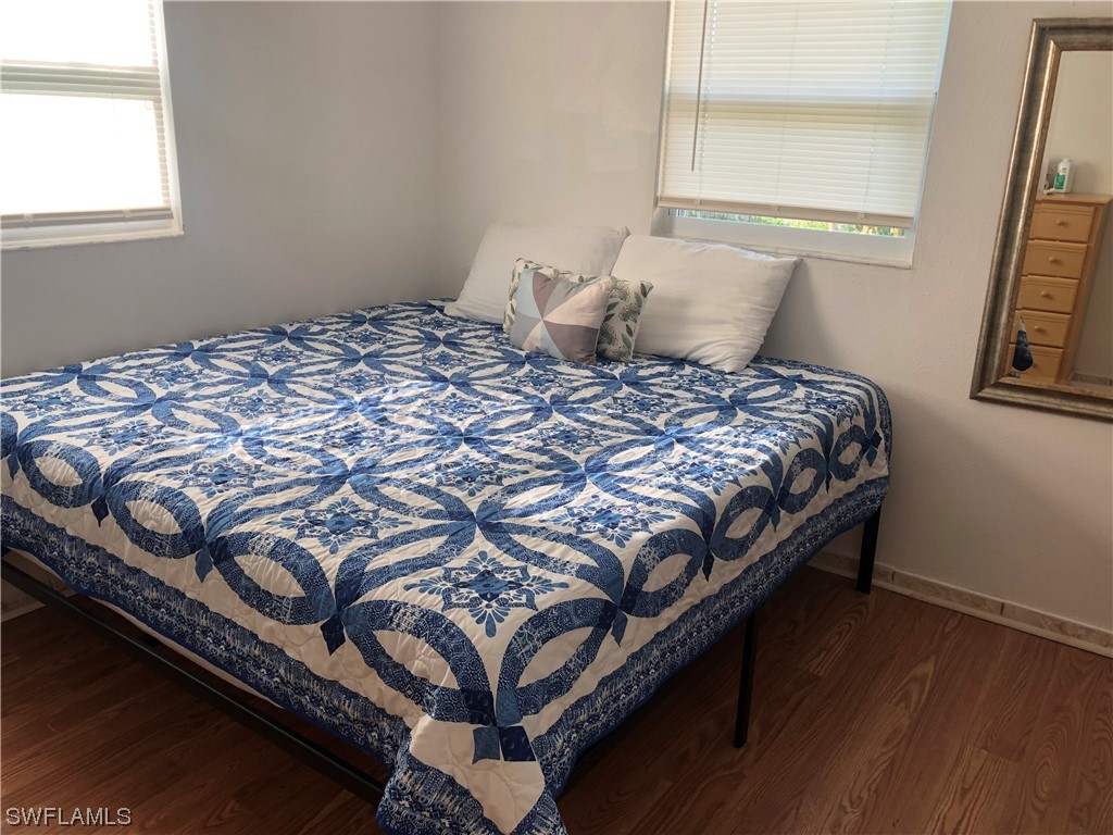 208 Davis Road Lehigh Acres, FL 33936 - Photo 17 of 20 a bedroom with a bed and wooden floor
