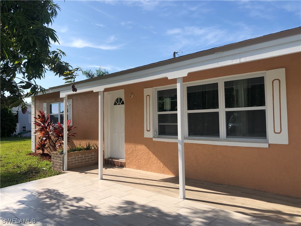 208 Davis Road Lehigh Acres, FL 33936 - Photo 2 of 20 a view of a house with a backyard