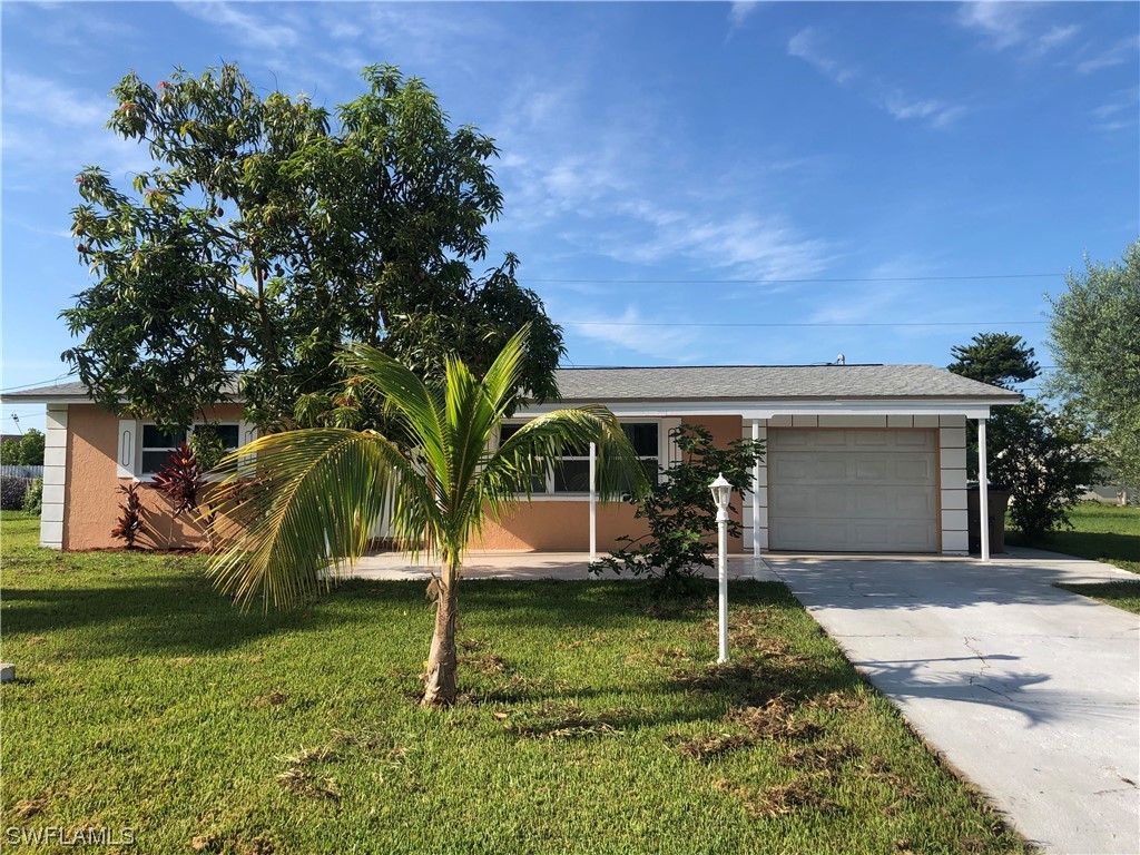 208 Davis Road Lehigh Acres, FL 33936 - Photo 3 of 20 front view of a house with a yard