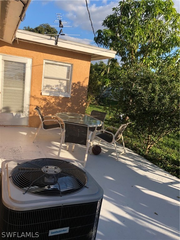 208 Davis Road Lehigh Acres, FL 33936 - Photo 5 of 20 a living room with furniture and a floor to ceiling window