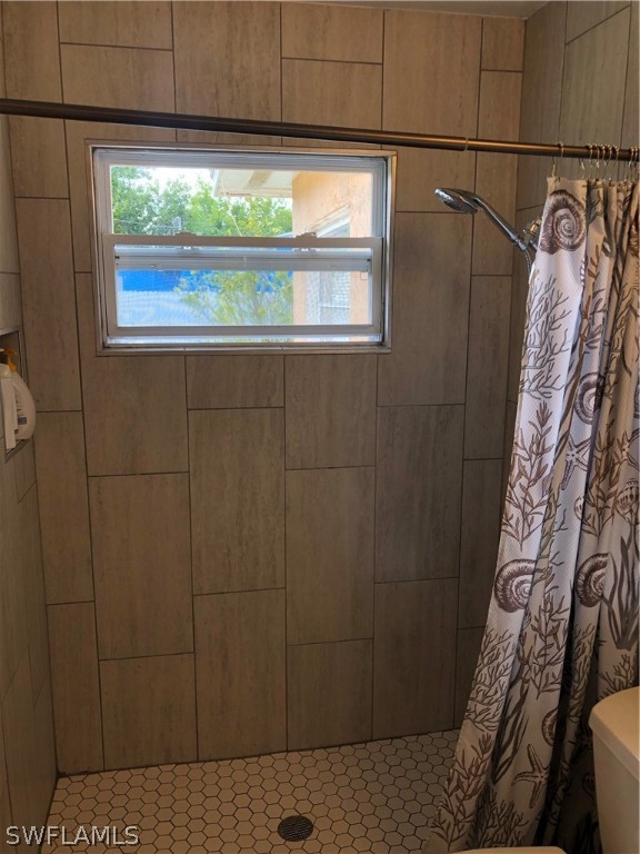 208 Davis Road Lehigh Acres, FL 33936 - Photo 9 of 20 a bathroom with a window and a shower