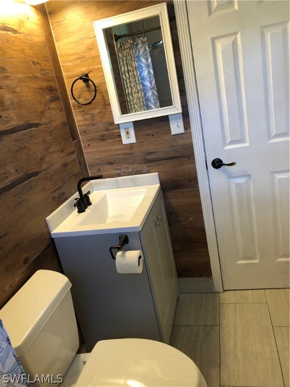 208 Davis Road Lehigh Acres, FL 33936 - Photo 10 of 20 a bathroom with a toilet and a sink