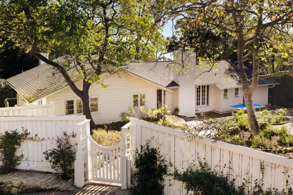 a front view of a house with a garden