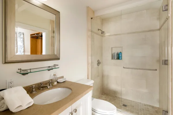 a bathroom with a sink toilet and shower