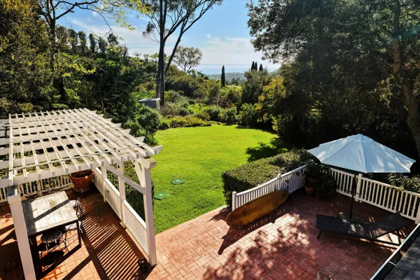 a view of a backyard with sitting area