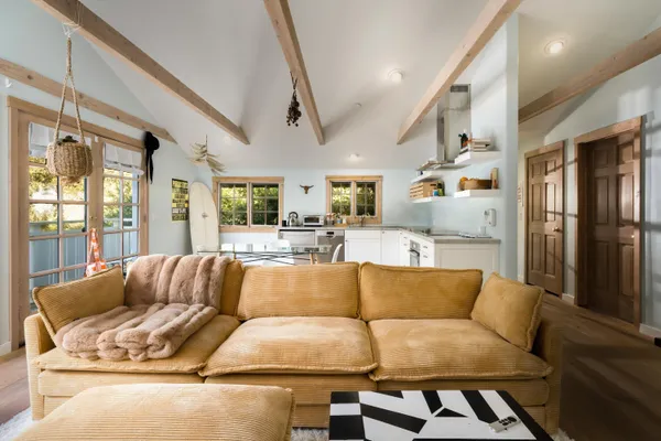 a living room with furniture fireplace and a large window