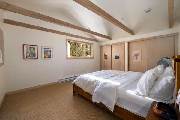 a bedroom with a bed and wall painting