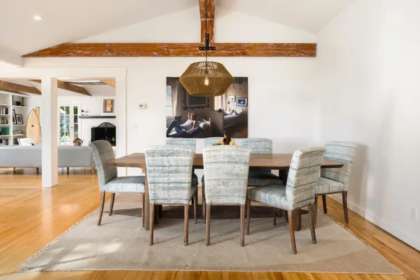 a dining room with furniture and wooden floor