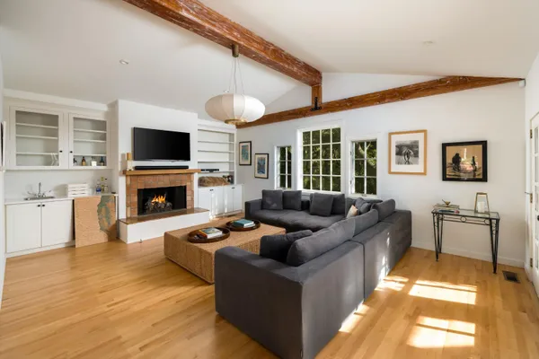 a living room with furniture a fireplace and a flat screen tv
