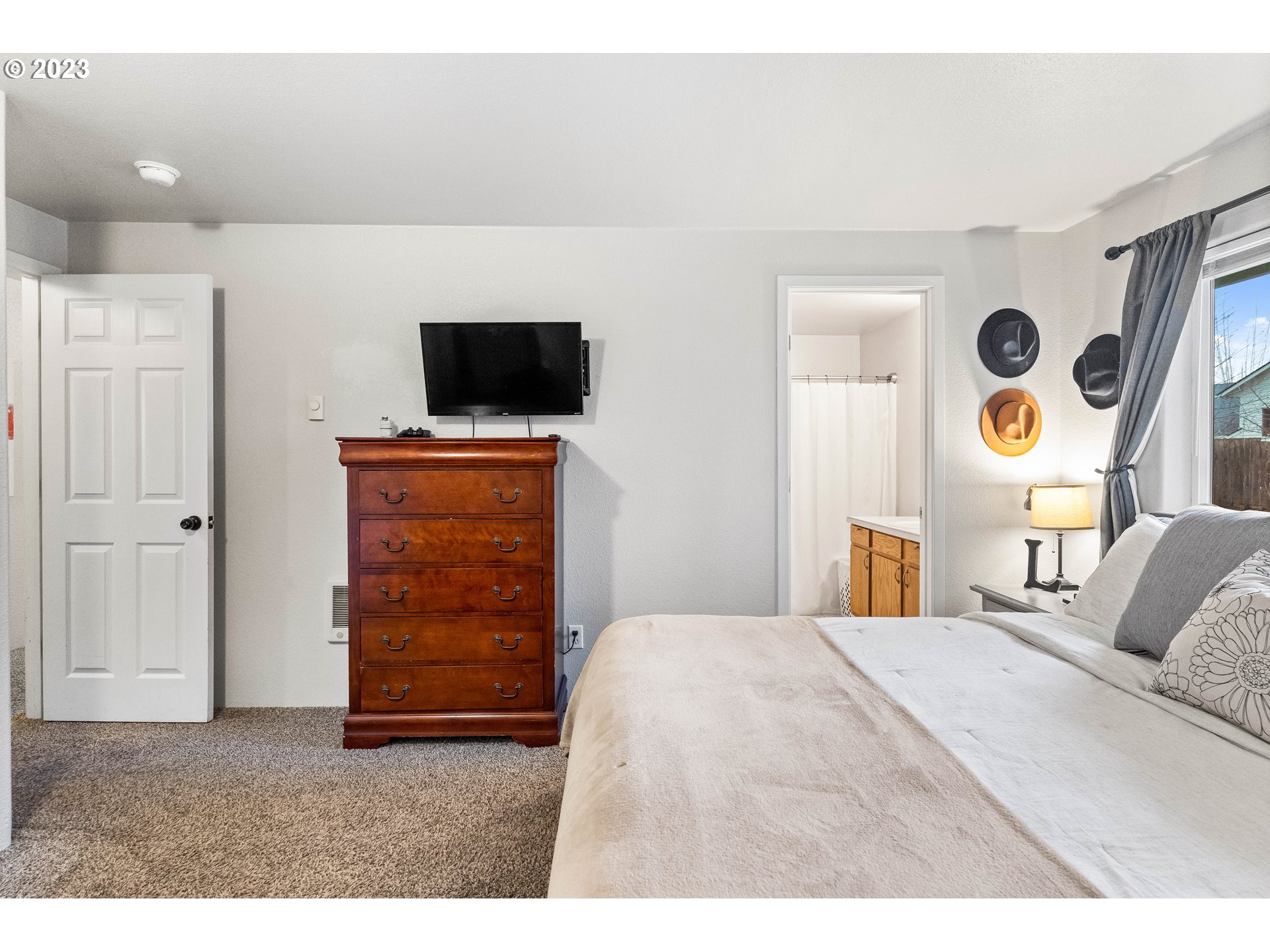 1484 Wiltsey Road Southeast Salem, OR 97306 - Photo 5 of 31 a bedroom with a bed and flat screen tv