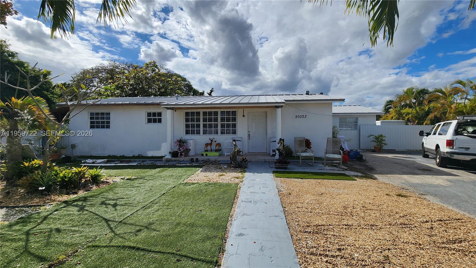 a view of a house with backyard and sitting area