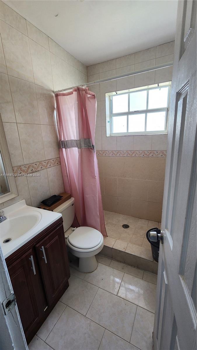 20022 Southwest 118th Avenue Miami, FL 33177 - Photo 12 of 23 a bathroom with a toilet sink and mirror