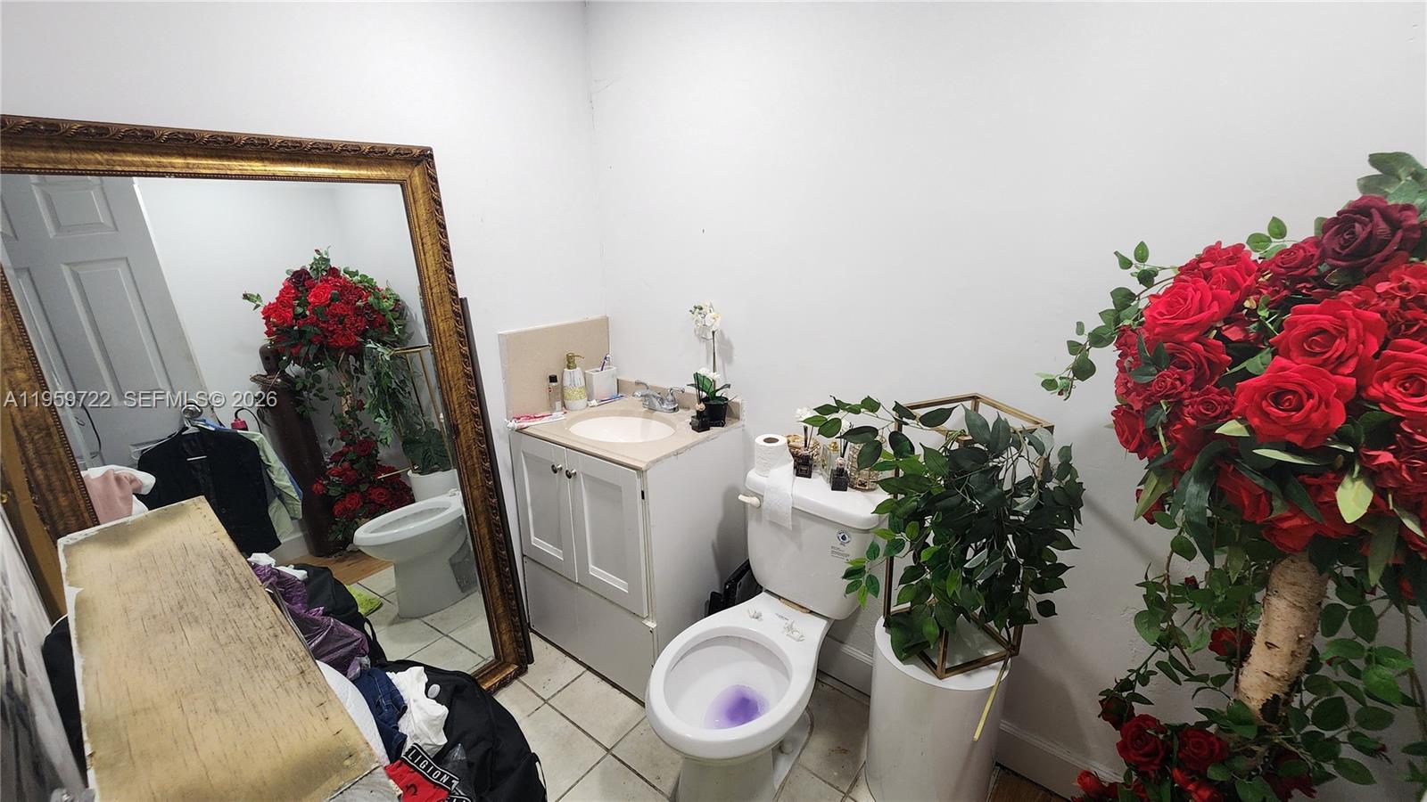 20022 Southwest 118th Avenue Miami, FL 33177 - Photo 13 of 23 a bathroom with a toilet and a mirror