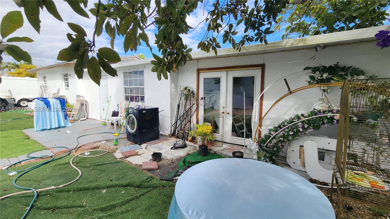 20022 Southwest 118th Avenue Miami, FL 33177 - Photo 18 of 23 a view of a chairs and table in backyard of the house
