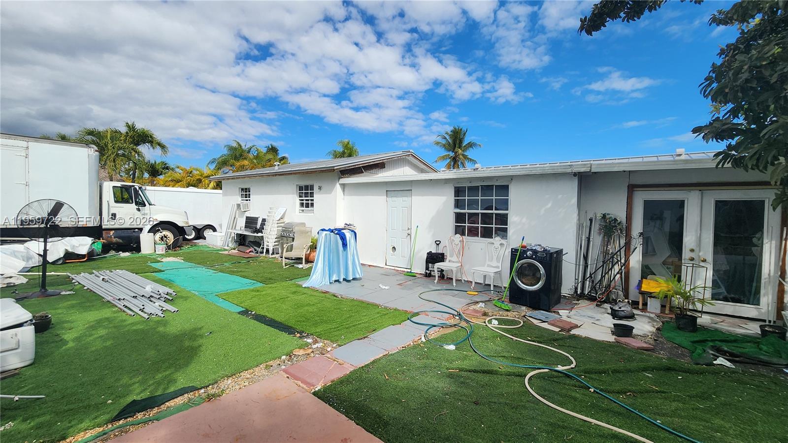 20022 Southwest 118th Avenue Miami, FL 33177 - Photo 20 of 23 a view of a house with backyard sitting area and garden