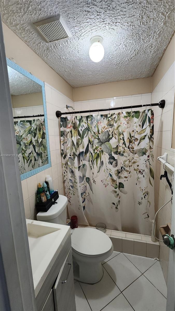 20022 Southwest 118th Avenue Miami, FL 33177 - Photo 9 of 23 a bathroom with a toilet and shower curtain