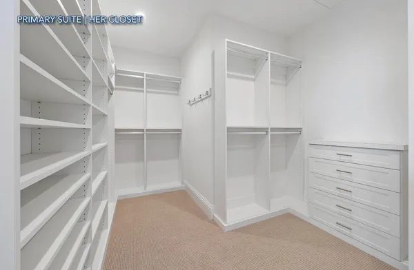 a view of walk in closet with empty racks
