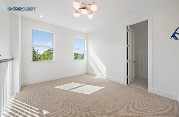 an empty room with windows and closet