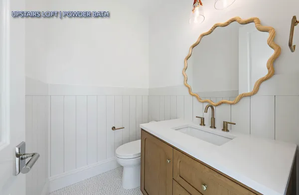 a bathroom with a sink vanity and a mirror