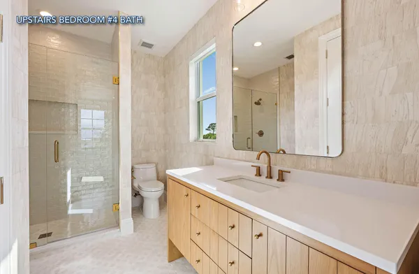 a bathroom with a shower sink and mirror