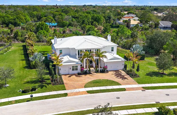 an aerial view of a house with yard swimming pool and outdoor seating