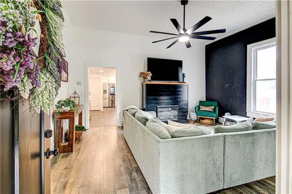 a living room with furniture and a fan