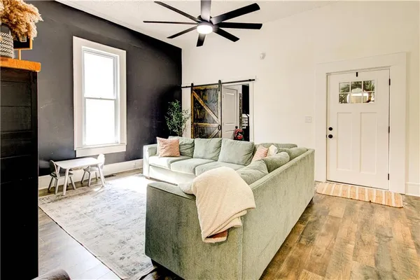 a kitchen with a refrigerator a stove a sink and chairs