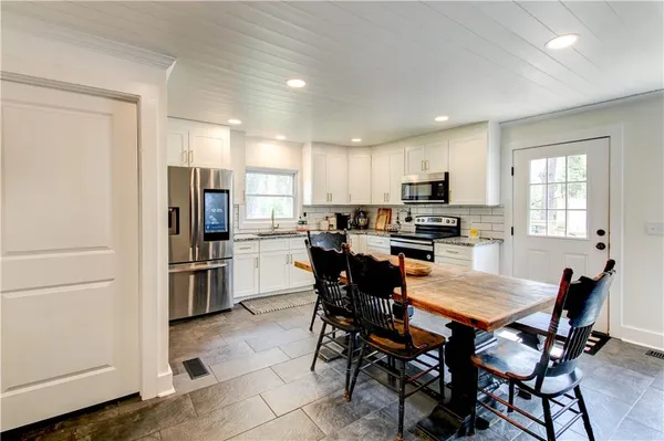 a dining room with furniture and window