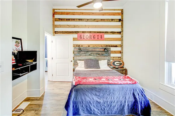a bedroom with a bed and a flat screen tv