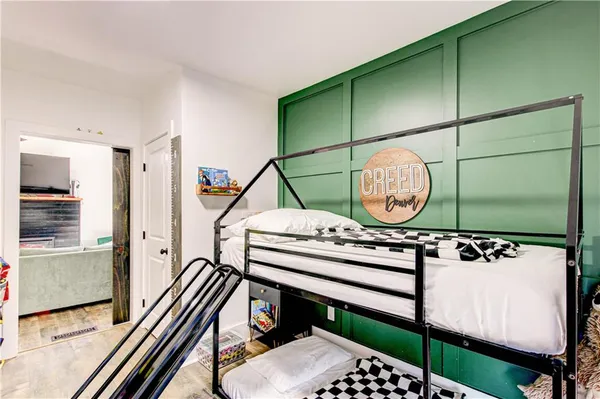 a living room with flat screen tv and a potted plant