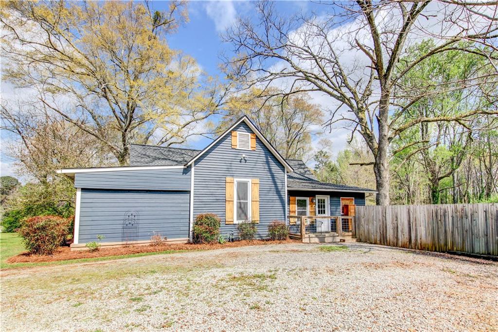 226 Mill Street Bowdon, GA 30108 - Photo 4 of 62 a front view of a house with a yard and wooden fence